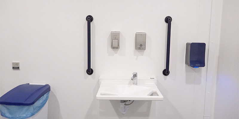 Ropox accessible washbasin with support rails installed in a Changing Place toilet