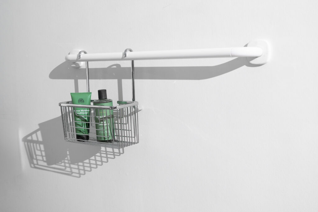 Close-up of Ropox shower grab bar wall mounting.